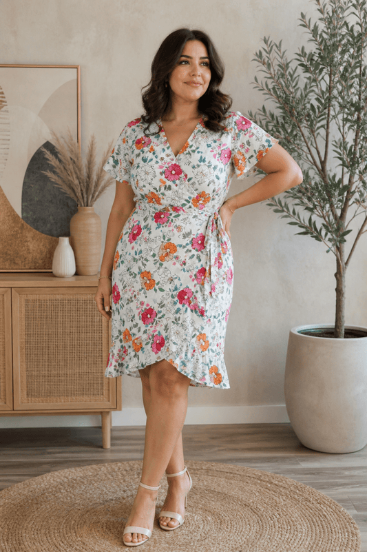 Floral white wrap midi dress with V-neckline and flutter sleeves, front view